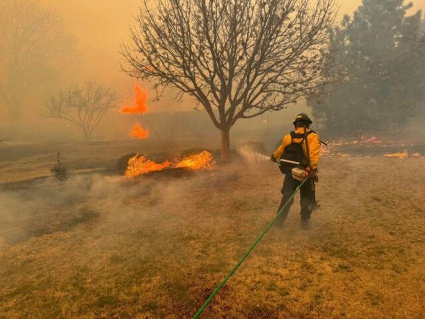 A firefighter battling the Smokehouse Creek Fire, near Amarillo, in the Texas Panhandle