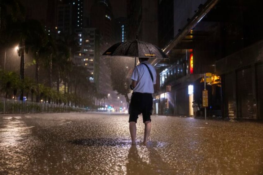 rain pouring onto hong kong and southern china floods city streets and subway stations