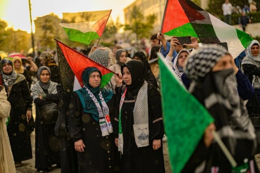 Protesters wave Palestian flags during a rally at the Uskudar Square in Istanbul, Turkey