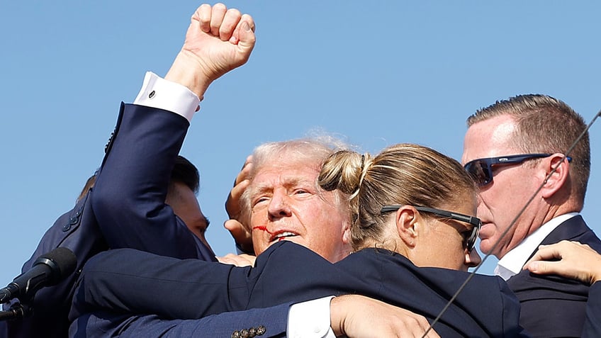 Republican presidential candidate former President Donald Trump is rushed offstage by U.S. Secret Service agents