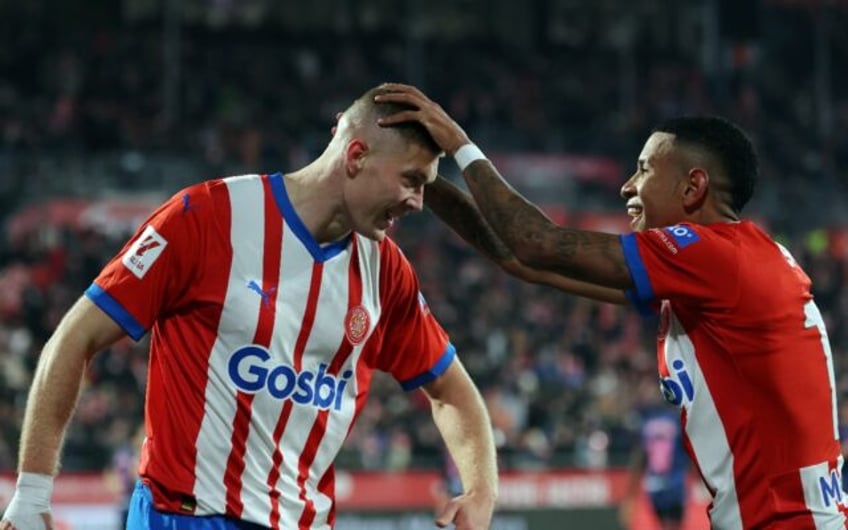 Girona's Ukrainian forward Artem Dovbyk (L) celebrates scoring his hat-trick as his side thrashed Sevilla to keep their La Liga lead