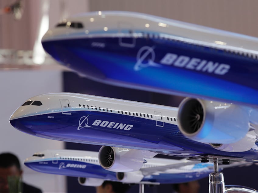 FILE- In this Nov. 6, 2018, file photo, models of Boeing passenger airliners are displayed during the Airshow China in Zhuhai city, south China's Guangdong province. China’s airline industry association has thrown its support behind 13 Chinese carriers seeking compensation from Boeing for groundings of the 737 Max 8. (AP Photo/Kin Cheung, File)