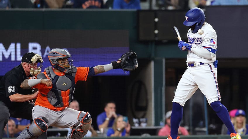 rangers adolis garcia hit by pitch and benches clear sparking ejections jose altuve hits go ahead homer