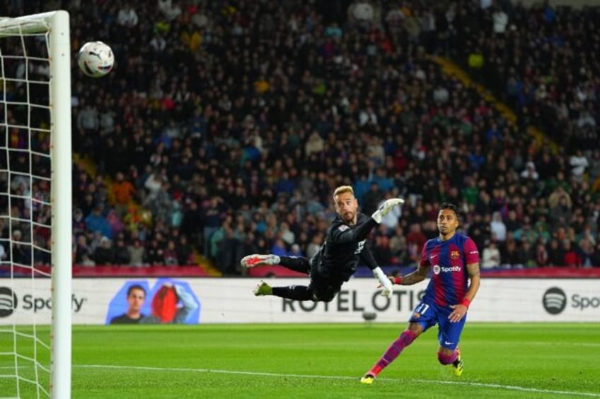 Barcelona's Brazilian forward Raphinha heads home past Las Palmas goalkeeper Aaron Escande