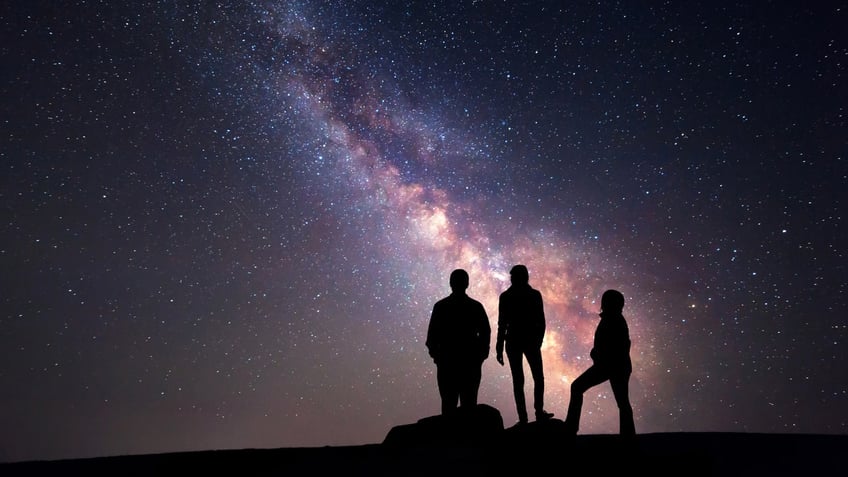 Night sky and silhouette of a family