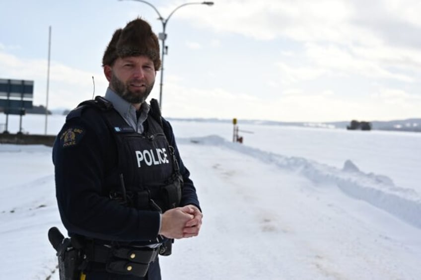 Royal Canadian Mounted Police Corporal Keven Rouleau stands near the Canada-US border, whe