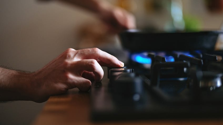 man preparing lunch in a pan in the kitchen.