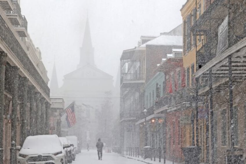 A cathedral in the French Quarter of New Orleans is barely visible in heavy snow that has