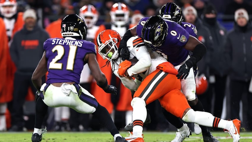 D'Onta Foreman (27) of the Cleveland Browns is tackled by Roquan Smith (0) of the Baltimore Ravens during the second quarter at M&amp;T Bank Stadium Jan. 4, 2025, in Baltimore. 