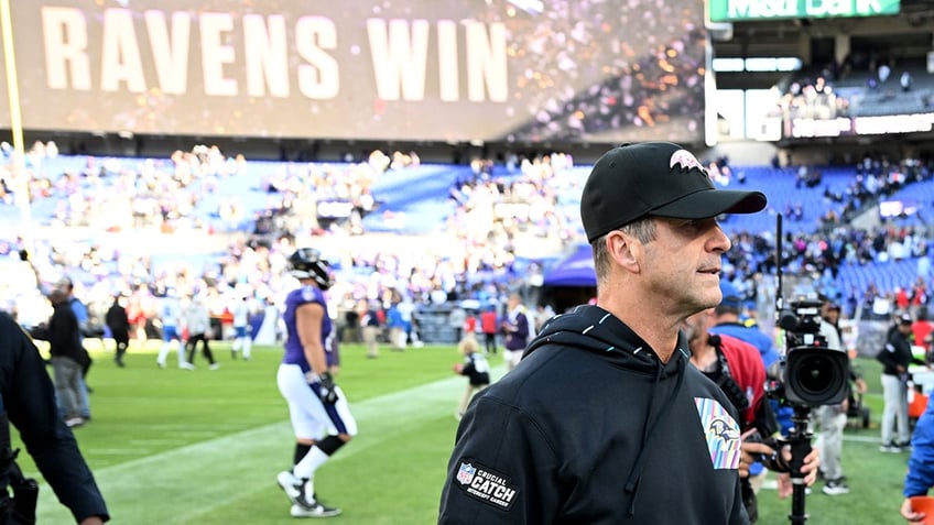 John Harbaugh walks off the field after a win