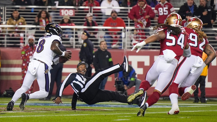 Ref falls as Lamar Jackson scrambles