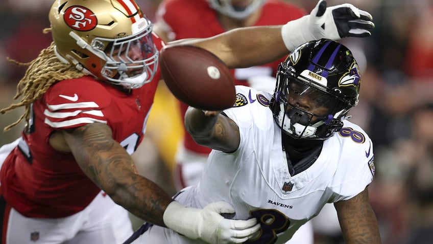 Lamar Jackson tosses the ball away