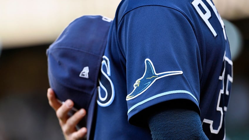 Rays player with cap over heart 