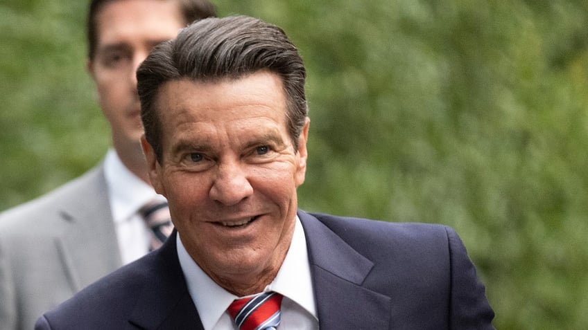 Actor Dennis Quaid smiles while portraying Ronald Reagan.