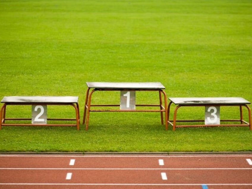 simple metal pedestal on green grass of stadium closeup