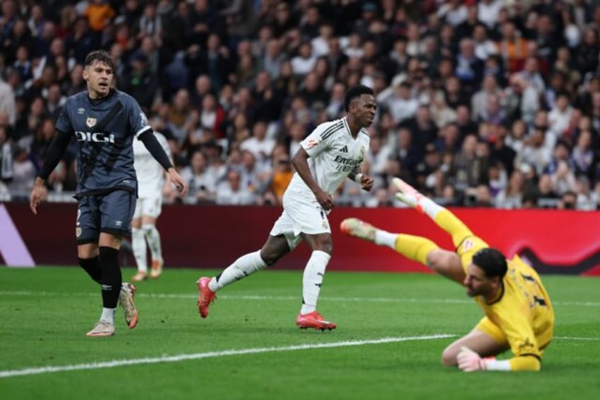 Real Madrid's Brazilian forward Vinicius Junior (C) celebrates scoring his team's second g