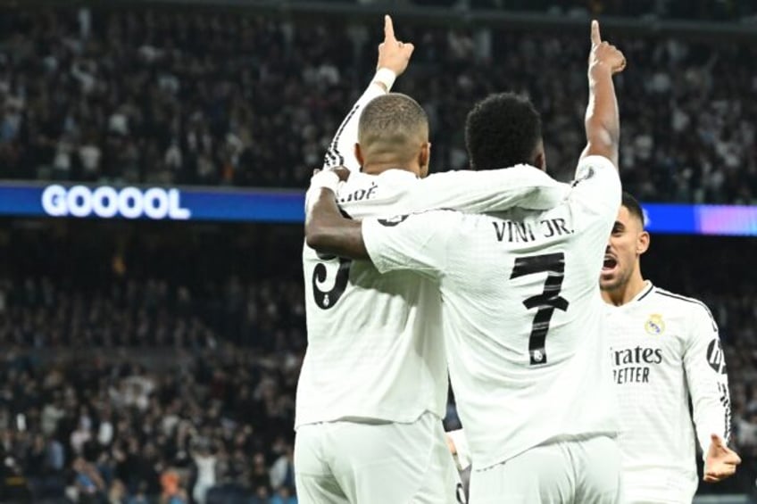 Real Madrid's French forward Kylian Mbappe (L) celebrates with Vinicius Junior during the