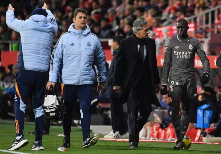 Real Madrid's French defender Ferland Mendy (R) leaves the pitch after an injury against G