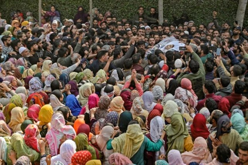 Relatives and mourners carry the body of a doctor killed in an October terror attack in Ka