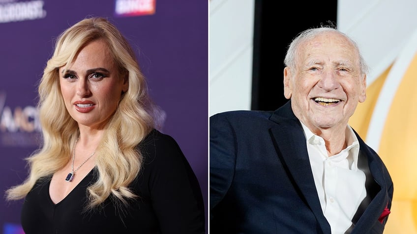 Rebel Wilson in a black dress looks directly into the camera on the carpet split Mel Brooks in a black suit sits on stage