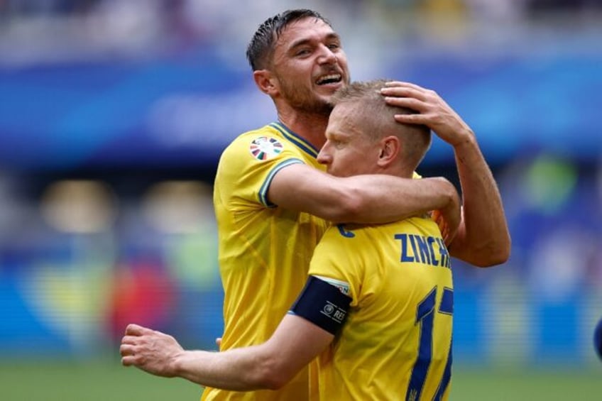 Ukraine match-winner Roman Yaremchuk embraces Oleksandr Zinchenko after the 2-1 victory ov