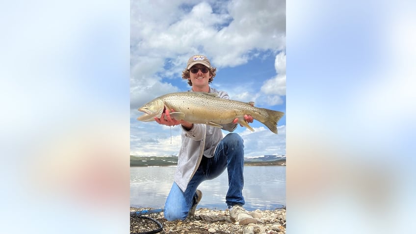 Owen Schaad holds up tiger trout