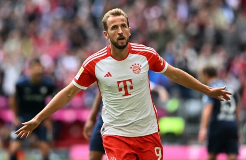 record setting kane hits hat trick as bayern rout bochum