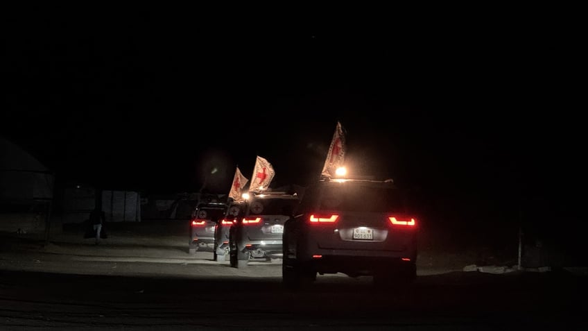 Red Cross vehicles carrying hostages' bodies