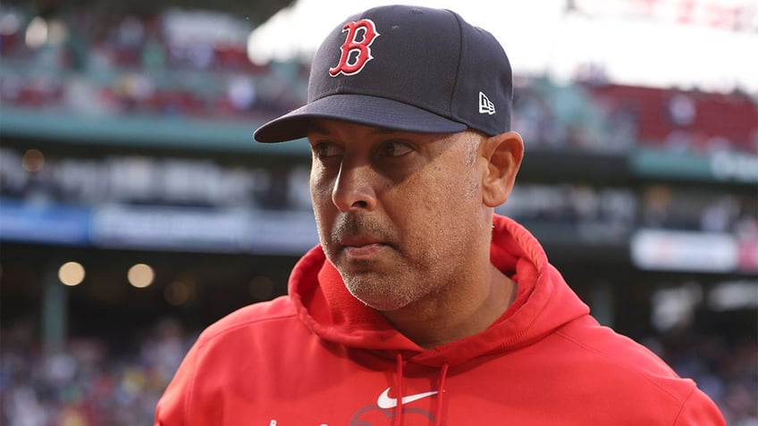 Alex Cora looks on before a game against Seattle