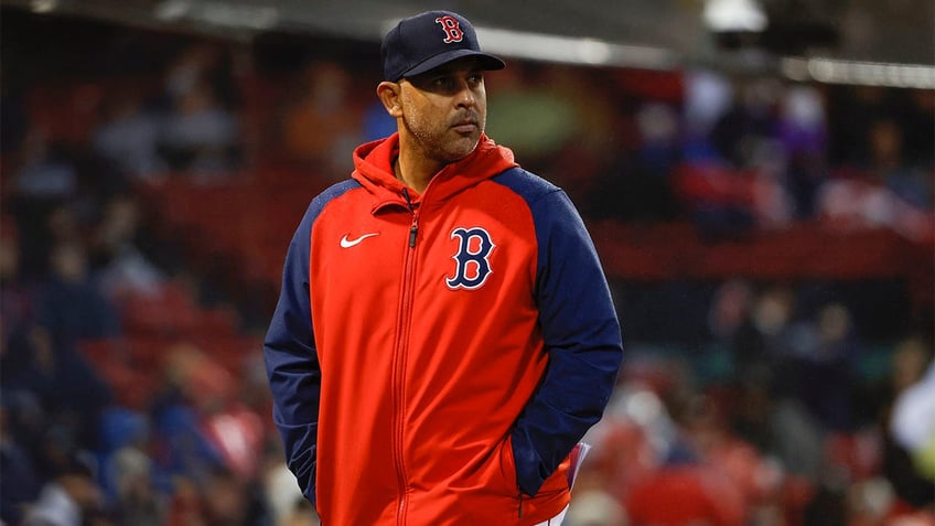 Alex Cora walks off the field