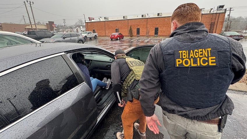 An ICE officer and an agent with the Tennessee Bureau of Investigations prepare to transport an illegal alien from Venezuelan with ties to the Tren da Aragua gang. She was arrested for her role in an illegal commercial sex and sex trafficking enterprise out of Nashville motels from July 2022 through March 2024.