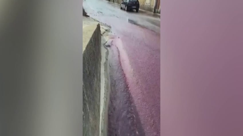 red wine flows through towns streets after distillery tank accident releases more than half a million gallons