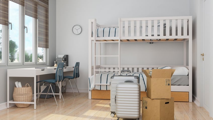 Modern College Dorm Room With Cardboard Boxes And Luggages