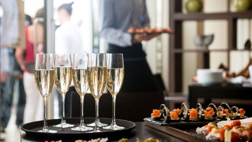 Wedding reception with champagne and canapes on table.