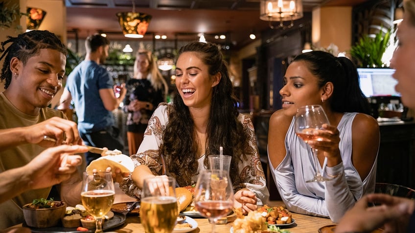 People laughing at group dinner