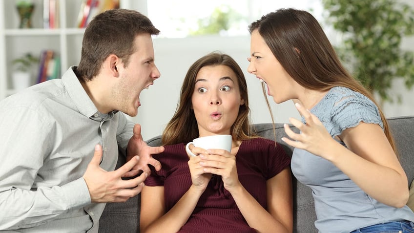 Three people fighting.