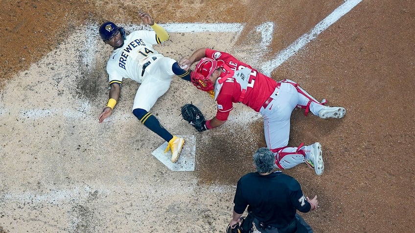 reds survive ninth inning surge from brewers to move within half game of nl central lead