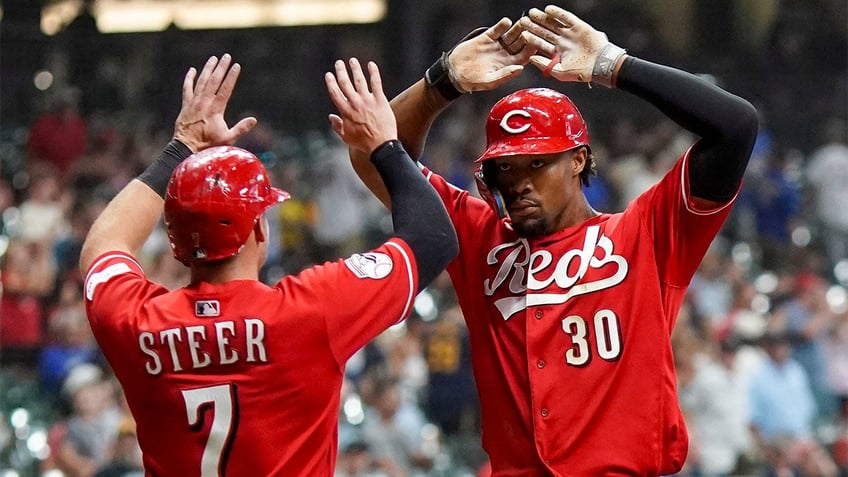 reds survive ninth inning surge from brewers to move within half game of nl central lead