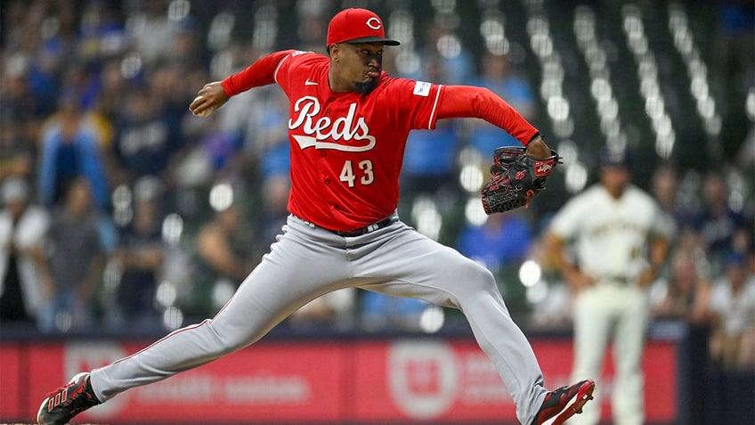 reds survive ninth inning surge from brewers to move within half game of nl central lead