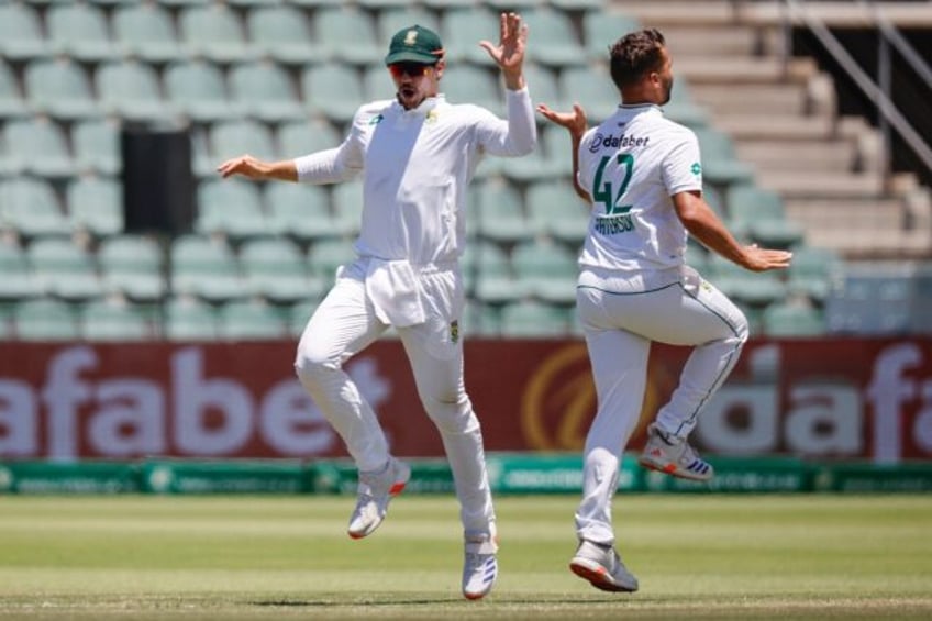 Dane Paterson (R) celebrates after the dismissing Sri Lanka's Dhananjaya de Silva