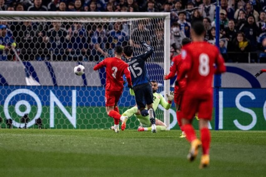 Japan's Daichi Kamada scores for the hosts