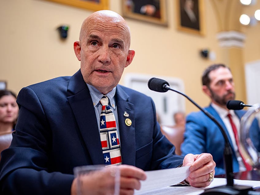 Rep. Keith Self (R-TX) (L), accompanied by Rep. Jason Crow (D-CO) (R), speaks during a Hou