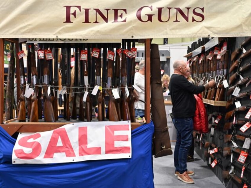 BIRMINGHAM, ENGLAND - FEBRUARY 23: Visitors view shotguns at a discount sale during The Br