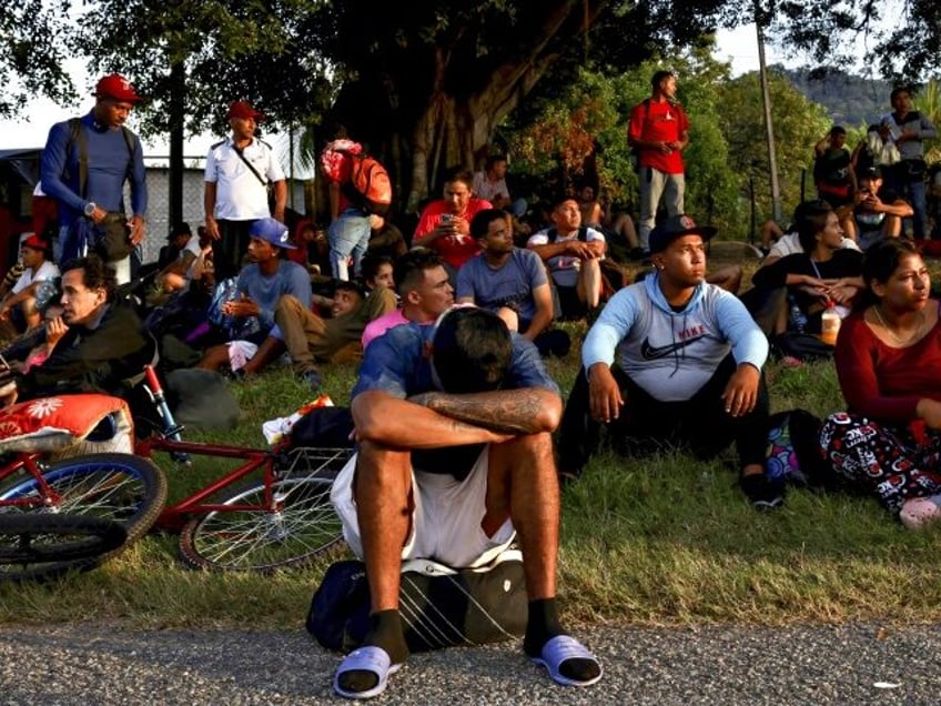 HUIXTLA, MEXICO - DECEMBER 3: A migrant sleeps while sitting up as he advances in a carava