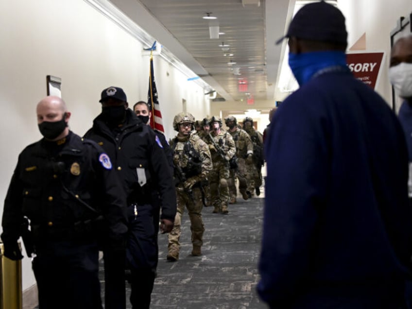 Members of the Federal Bureau of Investigation (FBI) swat team patrol the Longworth House