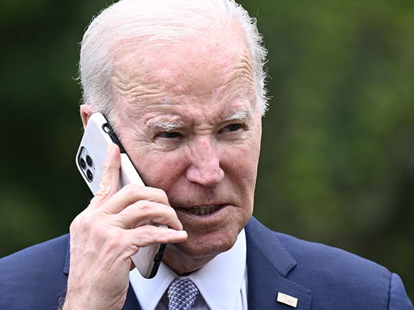 President Joe Biden speaks on the phone during a National Small Business Week event in the