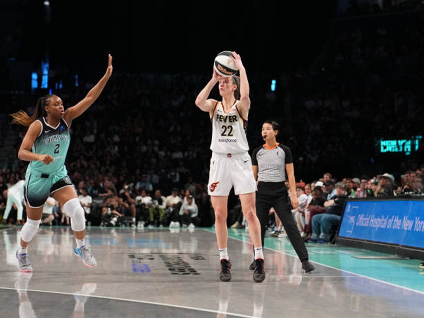 Caitlin Clark of the Indiana Fever shoots a three point basket during the game against the New York Liberty during a 2024 Commissioner's Cup game on...