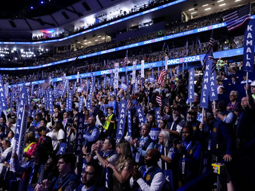 Delegates listen as Democratic presidential nominee Vice President Kamala Harris speaks on