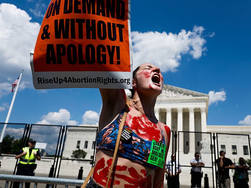 WASHINGTON, DC - JUNE 25: Abortion-rights activist Caroline Rhodes protests in front of th