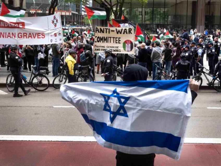 CHICAGO, ILLINOIS - MAY 14: A supporter of Israel taunts a group of pro-Palestinian activi